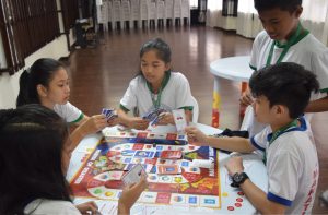 Children playing Master of Disaster boardgame